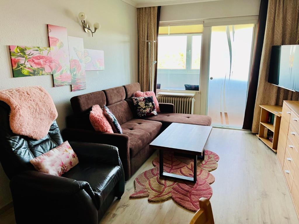 a living room with a couch and a table at Ferienwohnung 258 Haus Schleswig in Kalifornien