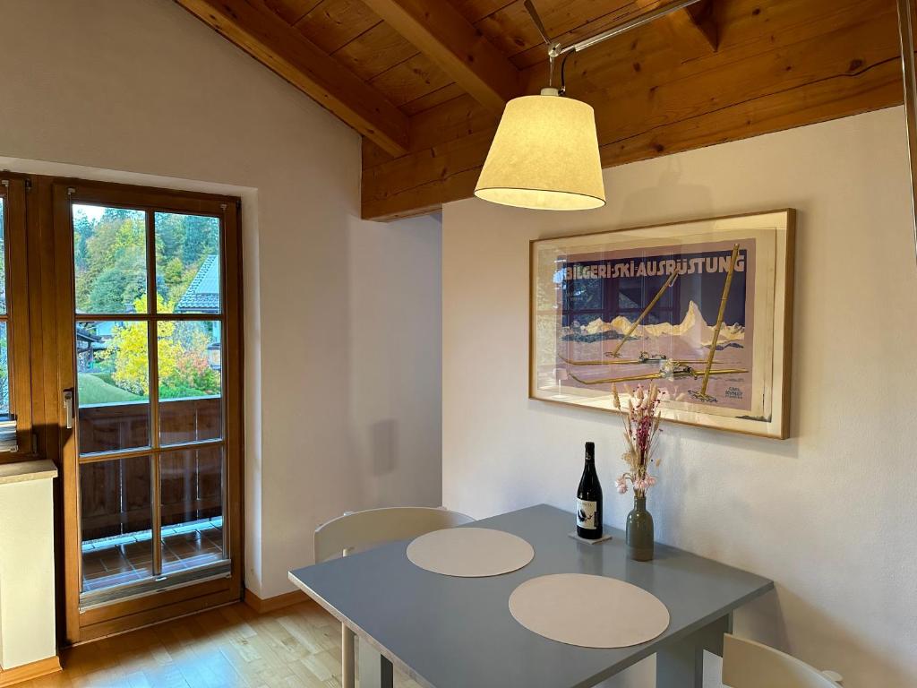 d'une salle à manger avec une table et une fenêtre. dans l'établissement Apartment mit Zugspitzblick, à Grainau