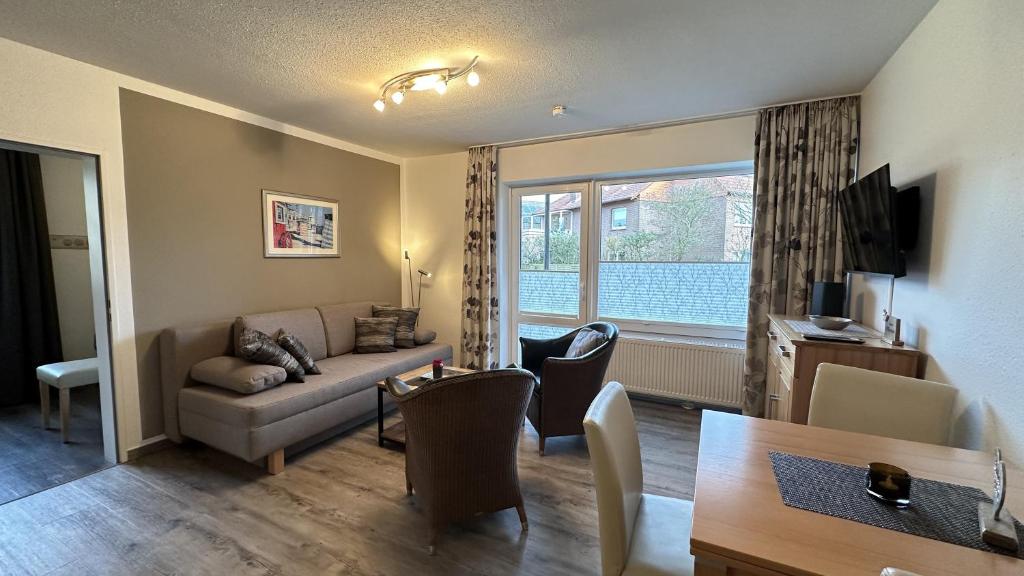 a living room with a couch and a table at Holiday Residenz Alter Leuchtturm in Borkum