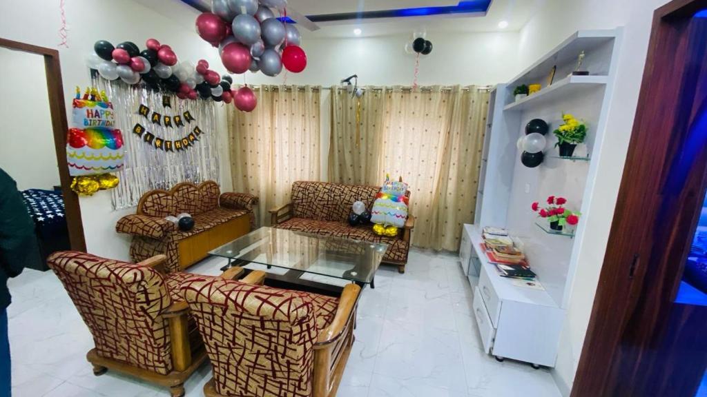 a living room with couches and a table and balloons at SBV Homes in Kharar