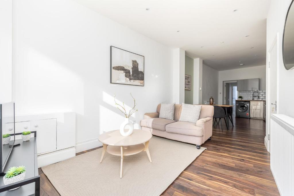 a living room with a couch and a table at The Peckham Apartments in London