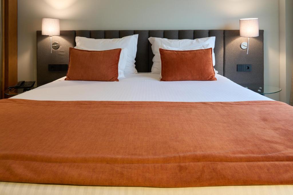 Uma cama ou camas num quarto em Hotel Versatile