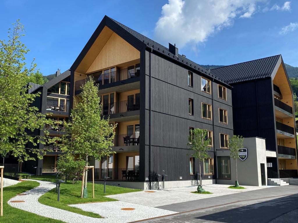 a black apartment building with a black roof at APART Resort Schruns in Schruns