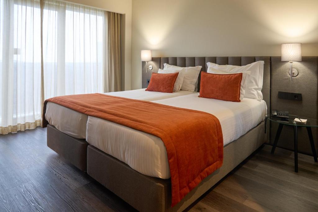 Uma cama ou camas num quarto em Hotel Versatile
