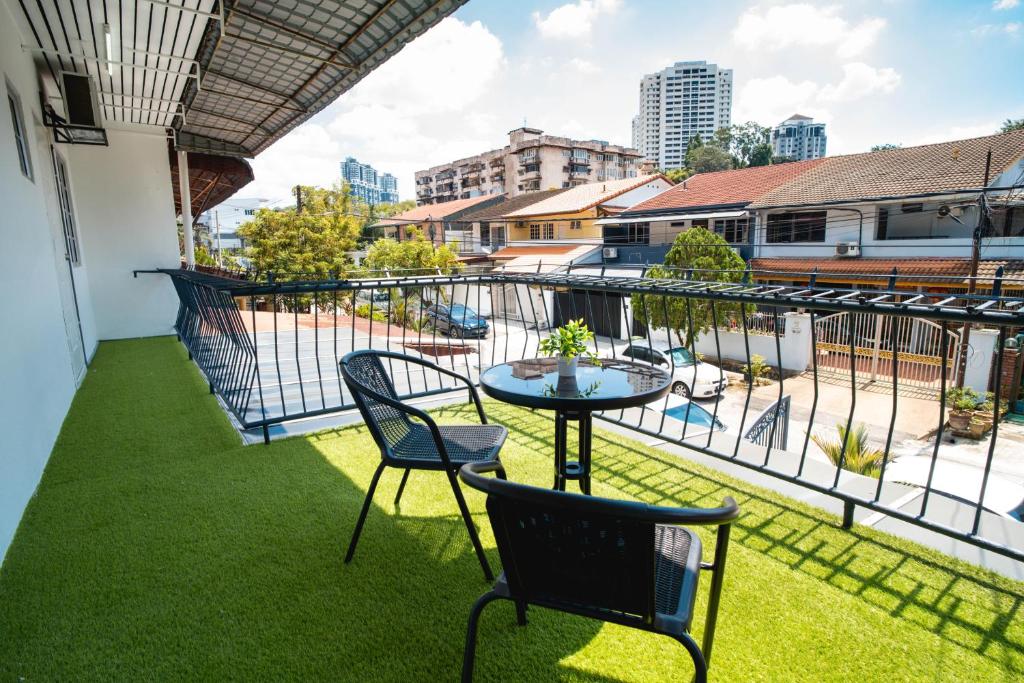 a patio with a table and chairs on a balcony at 10 mint drive to Mid Valley KL near Gateway Bangsar Seputeh in Kuala Lumpur
