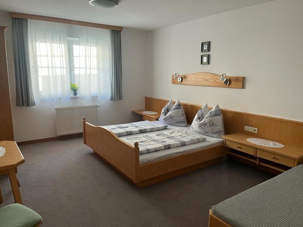 a hotel room with a bed and a window at Appartement Riepler in Wagrain