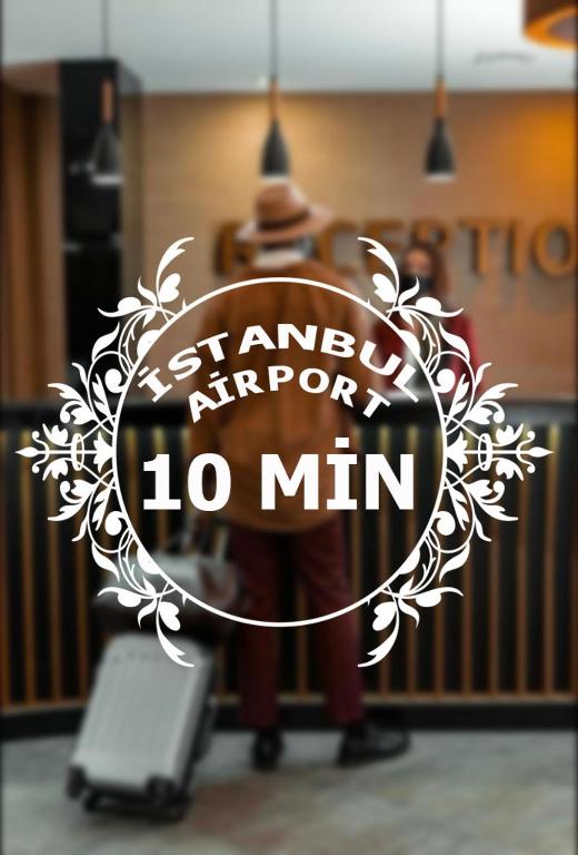 a man standing with a suitcase in a room at iNALENS AİRPORT KONAKLAMA in Arnavutköy