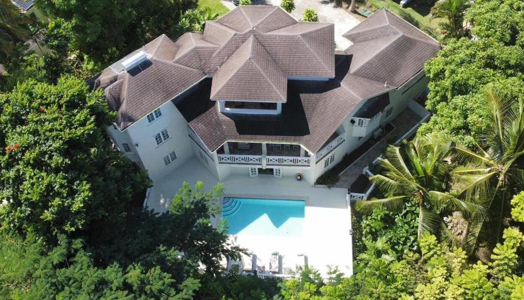 an aerial view of a house with a swimming pool at Gully Point in Saint James