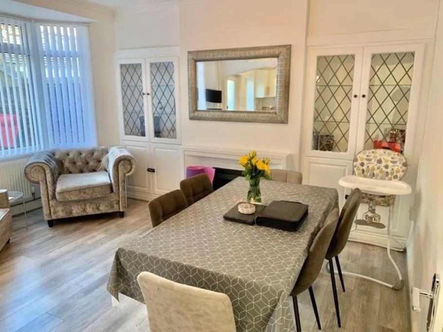 a dining room with a table and chairs and a mirror at 3 Bed Residential home - 5 mins from M4 in Port Talbot