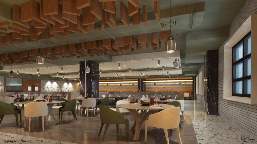 a restaurant with tables and chairs in a room at HOTEL SHUBHAM PALACE in Hyderabad