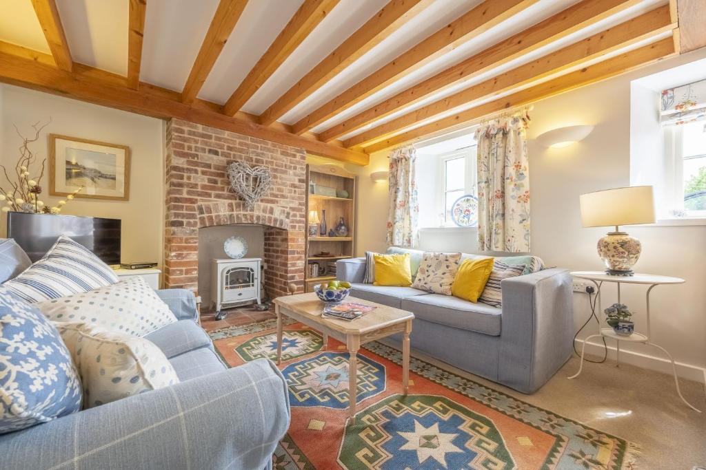 a living room with a couch and a fireplace at Seaview Cottage in Hunstanton