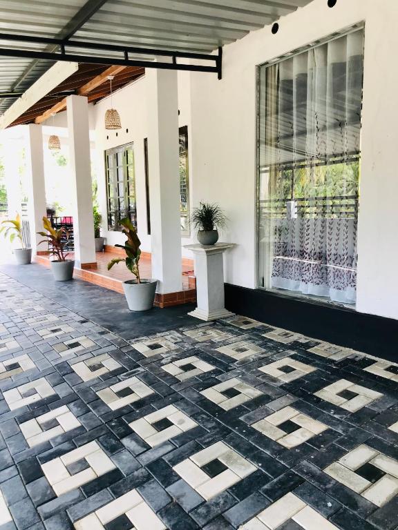an outdoor patio with a patterned tile floor at Hima House Mirissa in Mirissa
