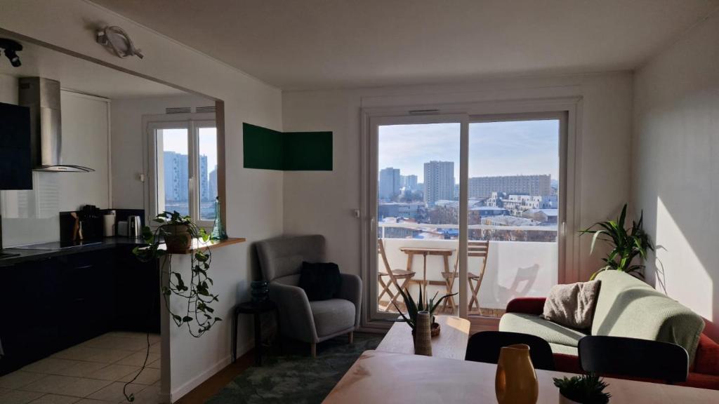 a living room with a view of a city at TILLON -Lumineux Balcon Transports- in Aubervilliers