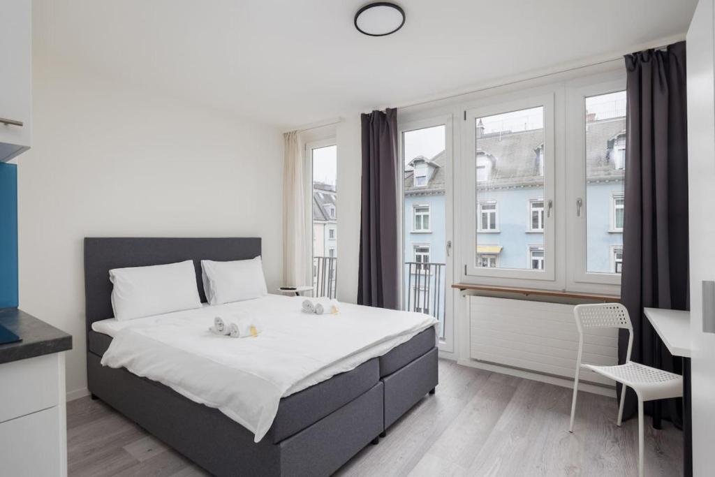 a bedroom with a bed and a large window at Urban Oasis with Queen Bed and View BE-44 in Zürich