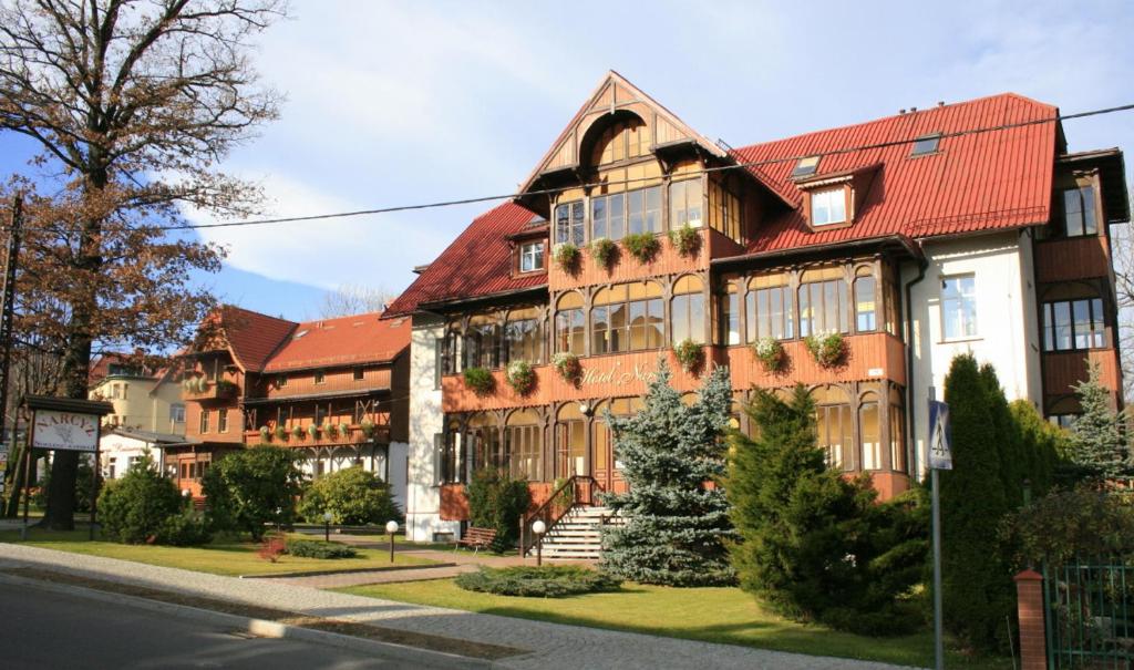 a large building with a red roof at Hotel Narcyz B in Świeradów-Zdrój