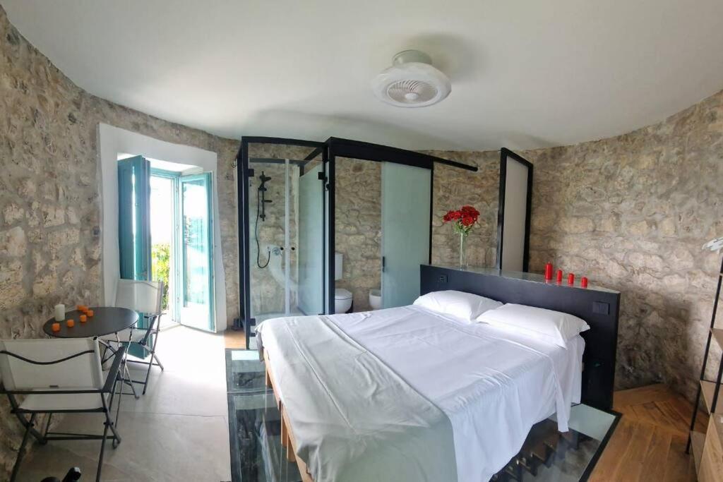a bedroom with a large white bed in a room at Torre del Principe suite in Salerno
