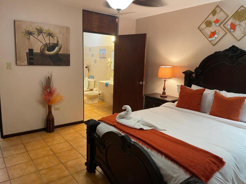 a bedroom with a large bed and a bathroom at Paradise Island in Isabela