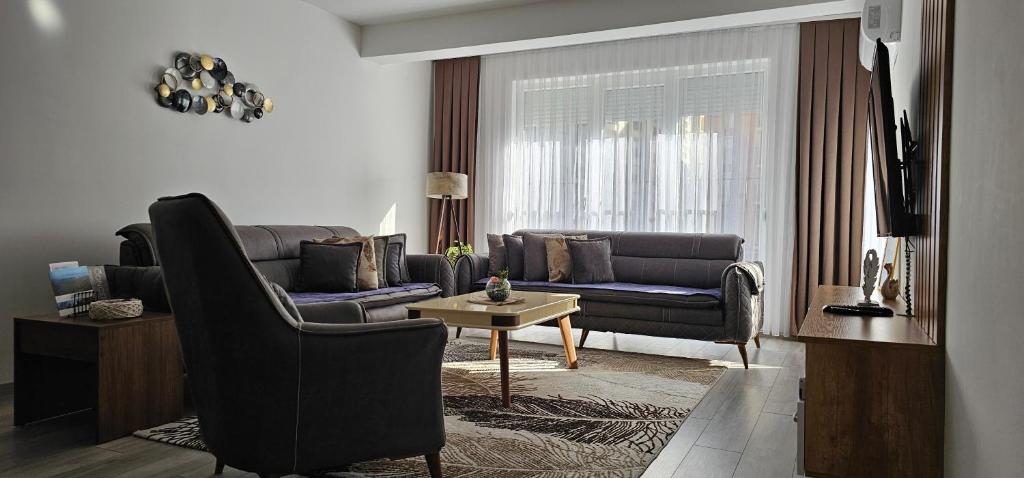 a living room with a couch and a table at Value Living Apartment in Ferizaj