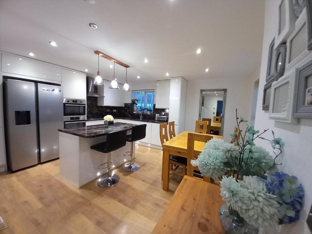 a kitchen and living room with a table and a counter at Turners Escape in Dinnington