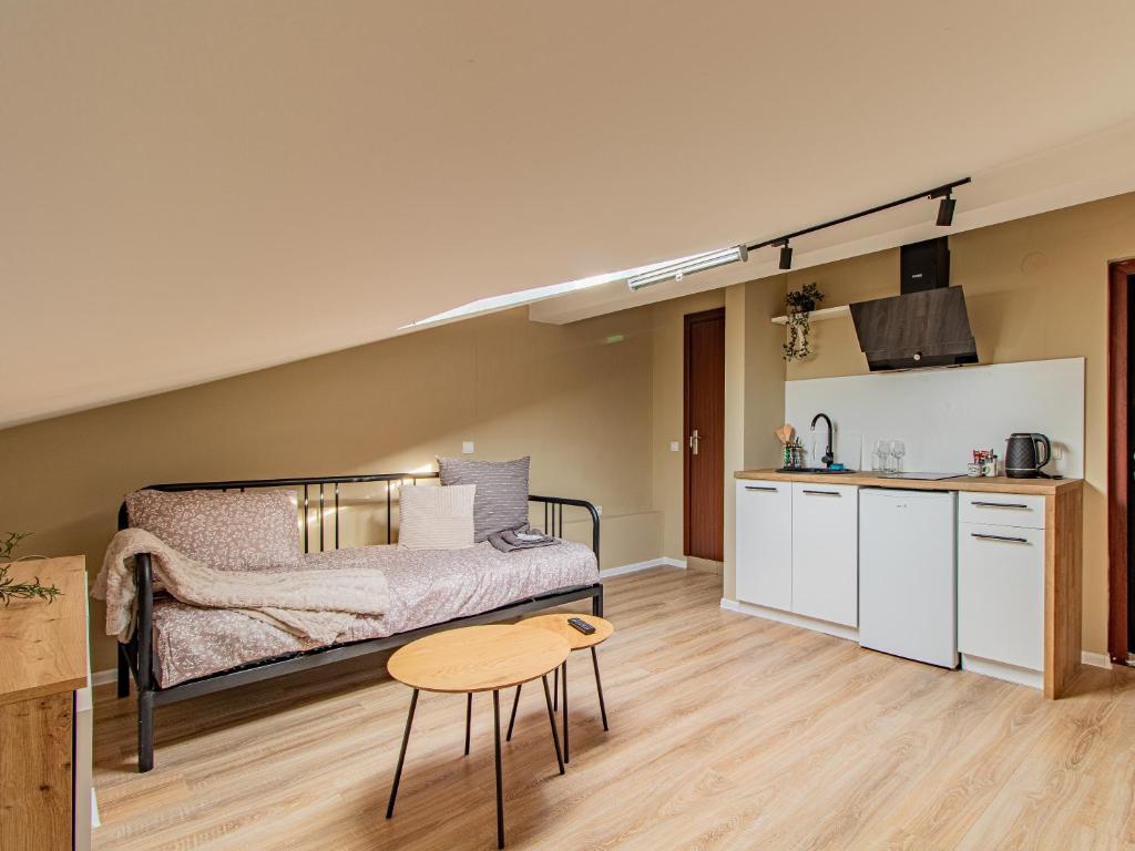 a room with a bed and a table and a kitchen at Skyline Studio - Sofia Center in Sofia