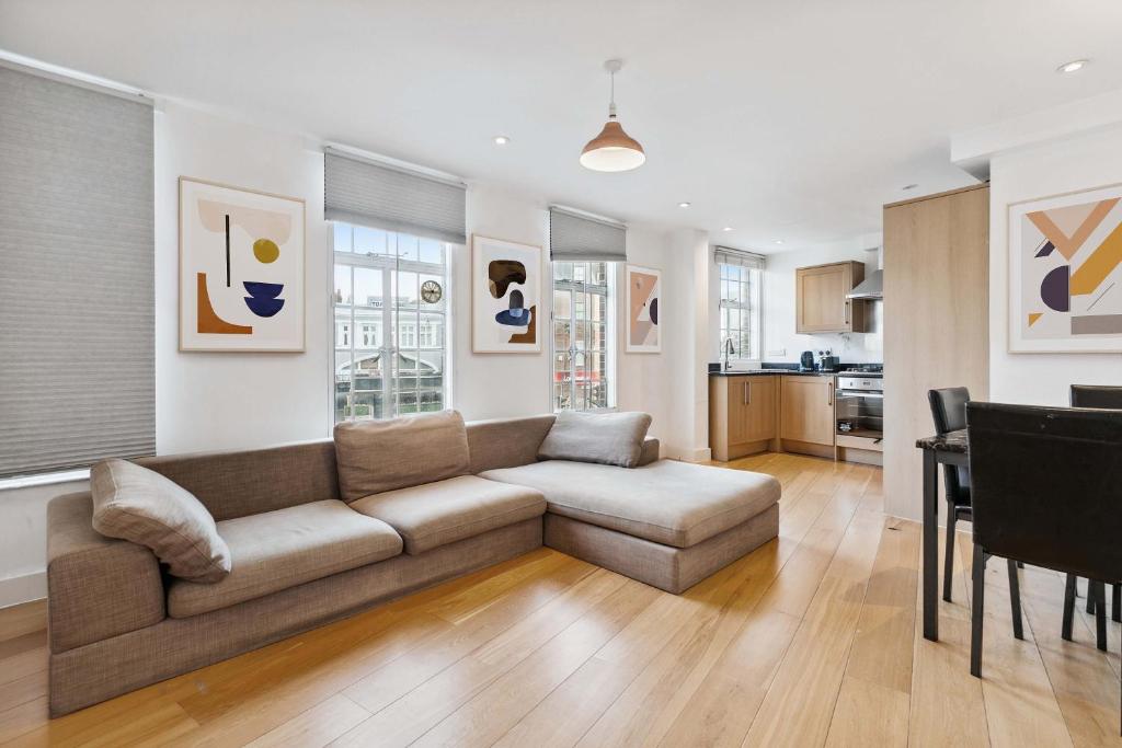 a living room with a couch and a table at Cozy Central London Residence Stockwell in London
