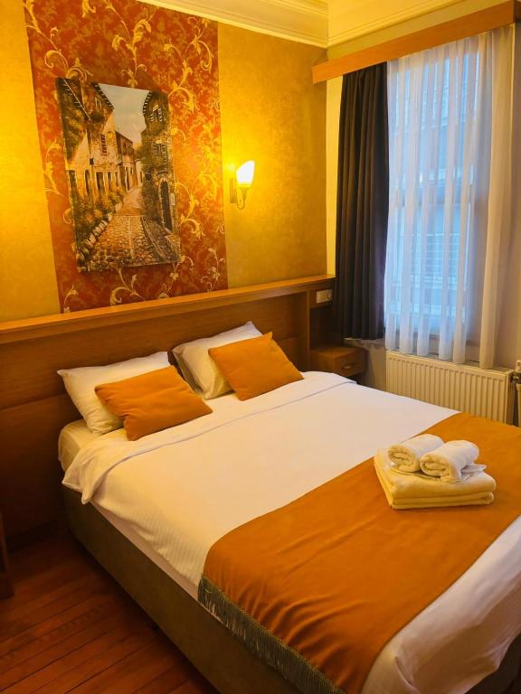 a bedroom with a bed with towels on it at Lebon Hotel-Special Class in Istanbul