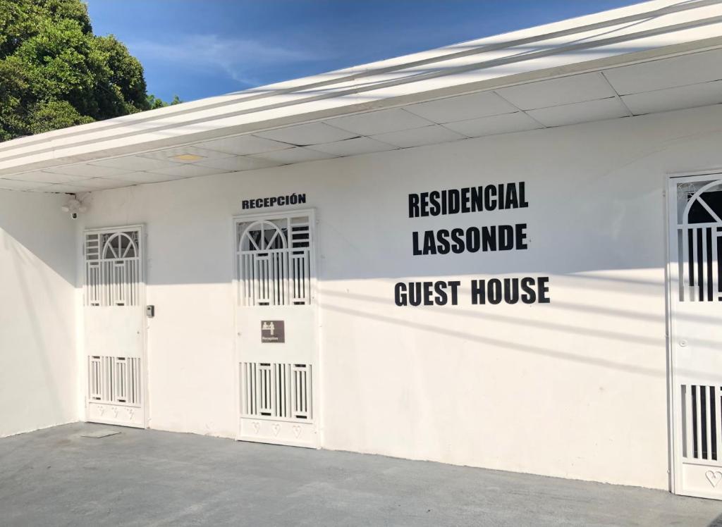 a white building with a guest house sign on it at Residencial Lassonde Guest House in David