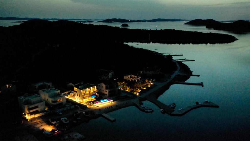 an aerial view of an island in the water at night at Bonaventura Residence in Murter