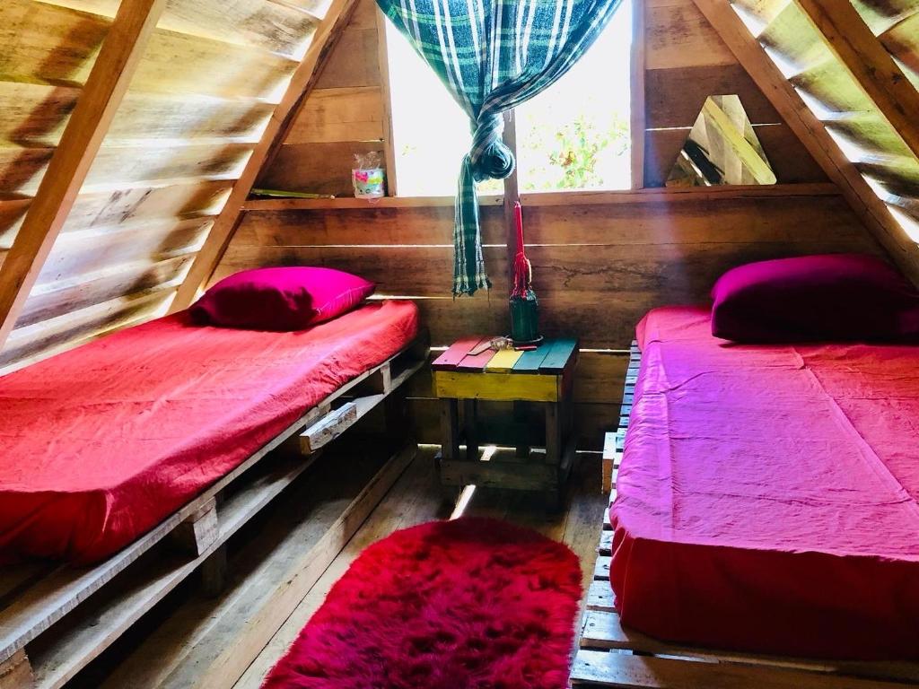 a bedroom with two beds and a window at Land of Promise - Reggae Escape in Zanderij