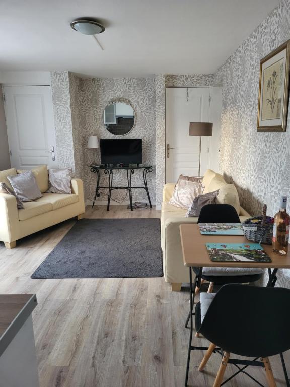 een woonkamer met een bank en een piano bij The apartment in Saint-Rabier