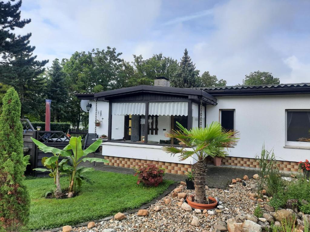 a white house with a black roof at Haus Seeblick in Roßbach