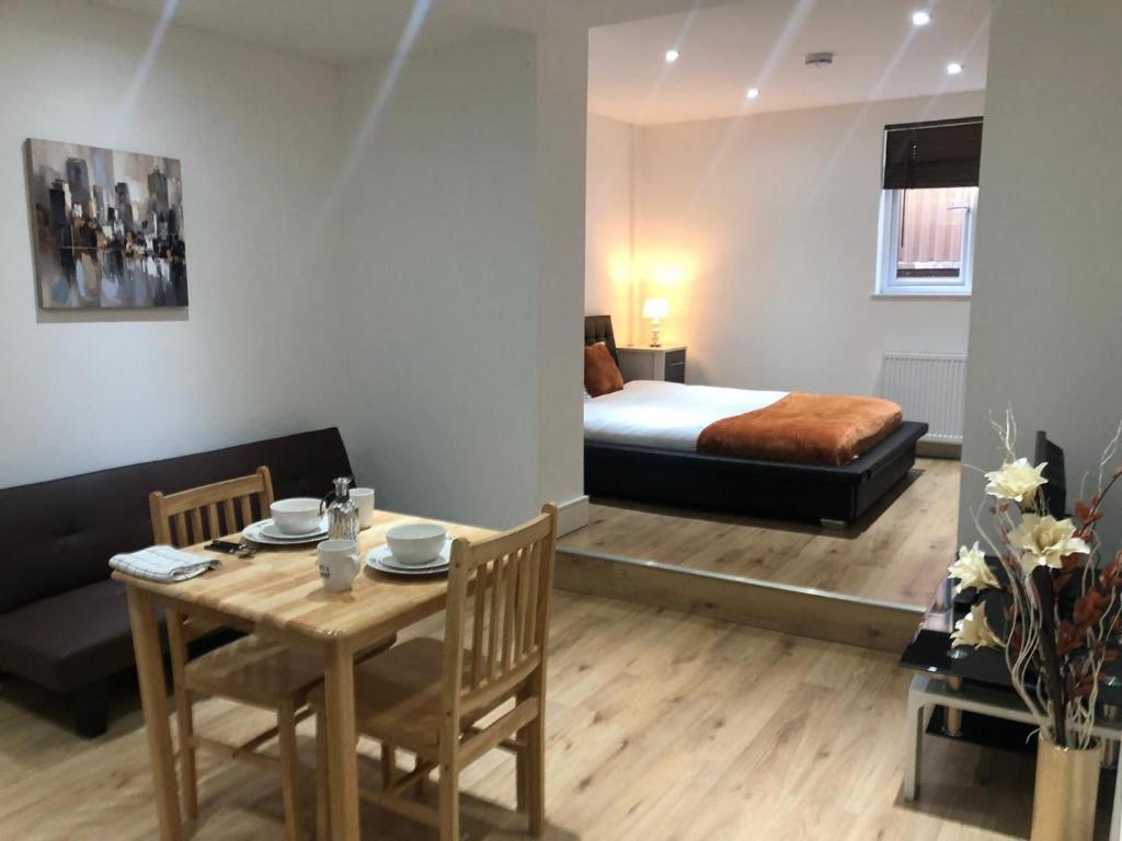 a room with a table and a bed and a bedroom at London Bermondsey 3 People Beautiful Studio in London
