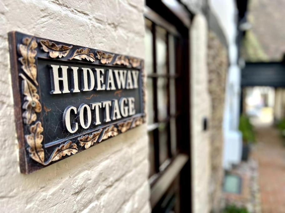 a sign on the side of a building at Hideaway Cottage in Ludlow