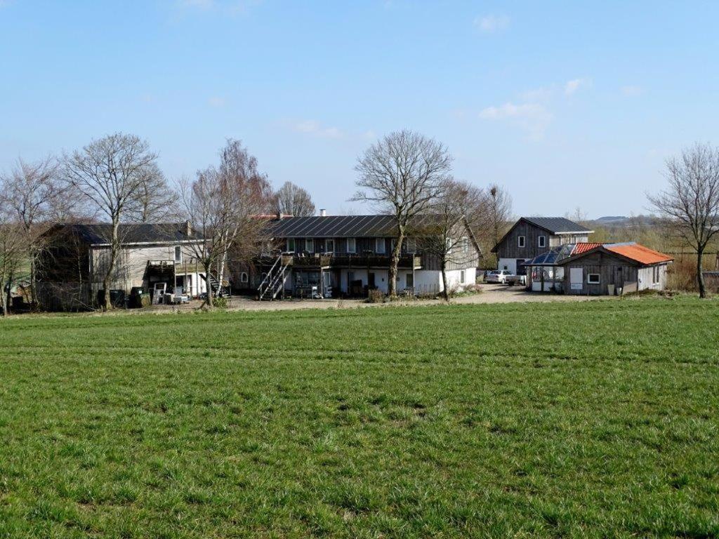 a large field of grass in front of a house at Billund countryside Appartement in Give