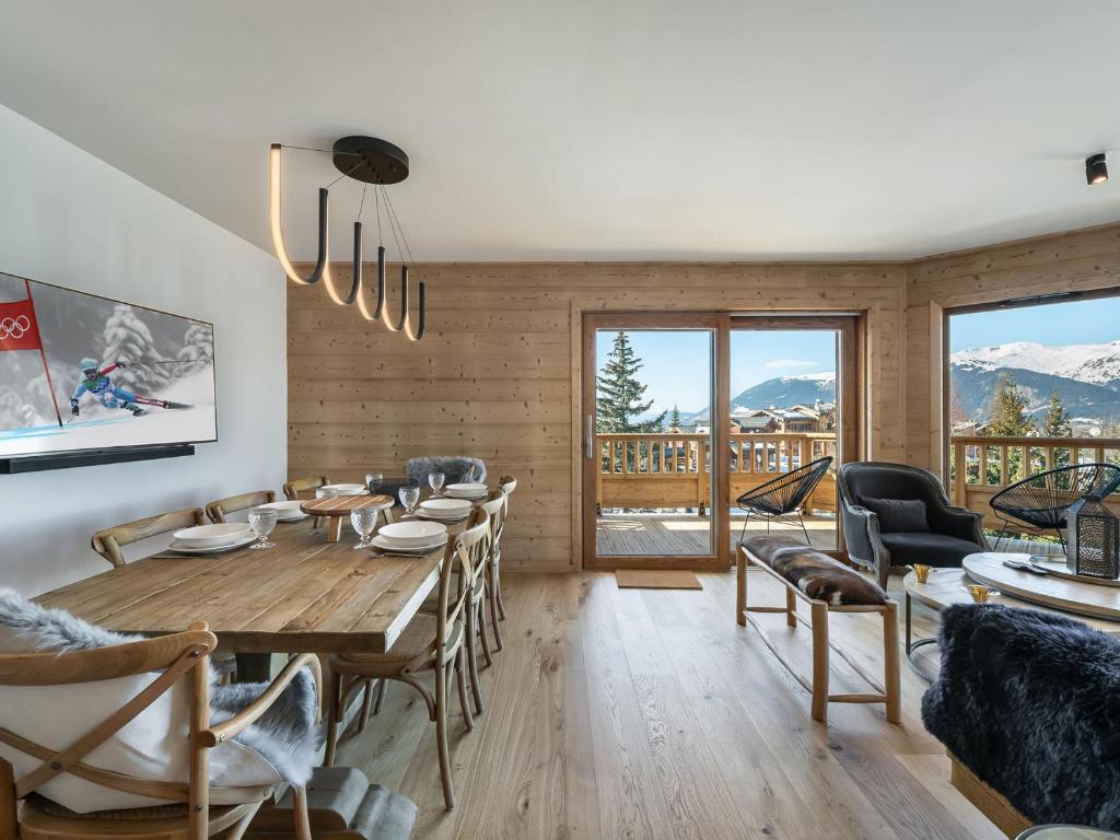 a dining room with a wooden table and chairs at Appartement Courchevel 1650, 4 pièces, 6 personnes - FR-1-563-36 in Courchevel