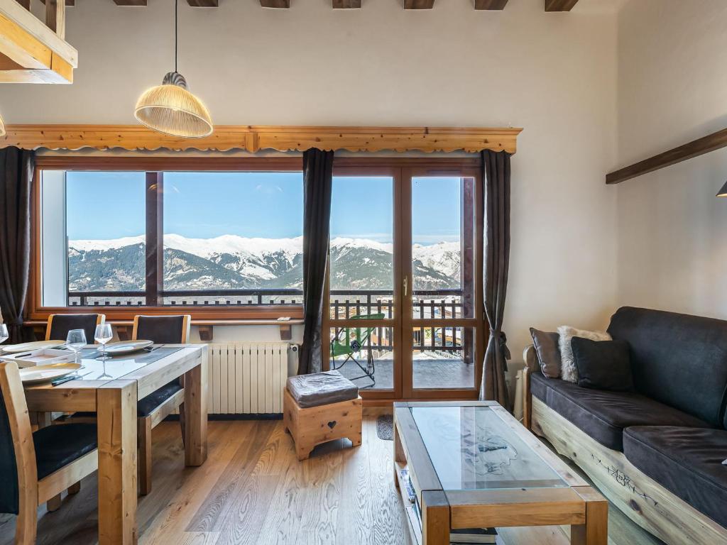 a living room with a table and a couch at Appartement Courchevel 1650, 2 pièces, 5 personnes - FR-1-563-70 in Courchevel