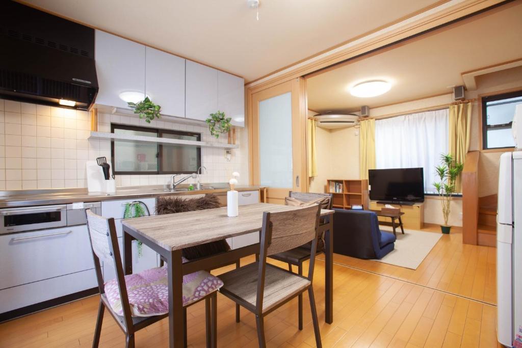 a kitchen and dining room with a table and chairs at Lucky Higashi Mizue - Vacation STAY 16180 in Tokyo