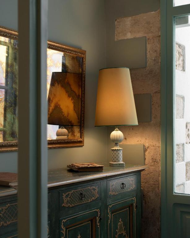 a lamp on a dresser in a room at Mythos Suites Boutique Hotel in Rethymno