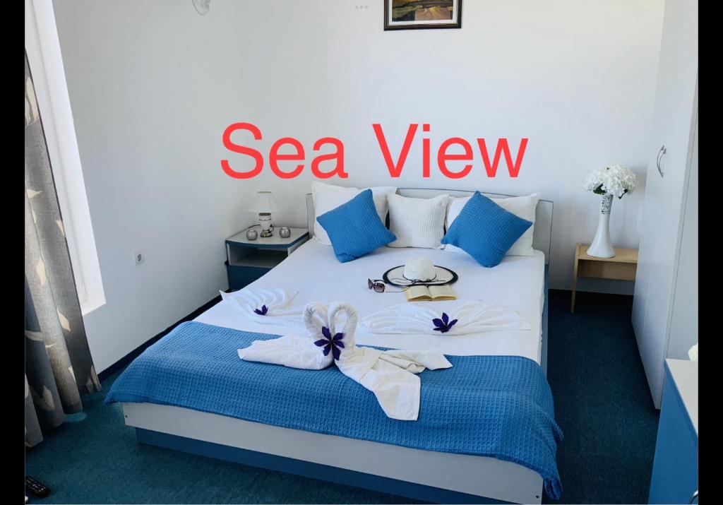 a hotel room with a bed with a sea view sign on it at Sea View Rooms Briz in Nesebar