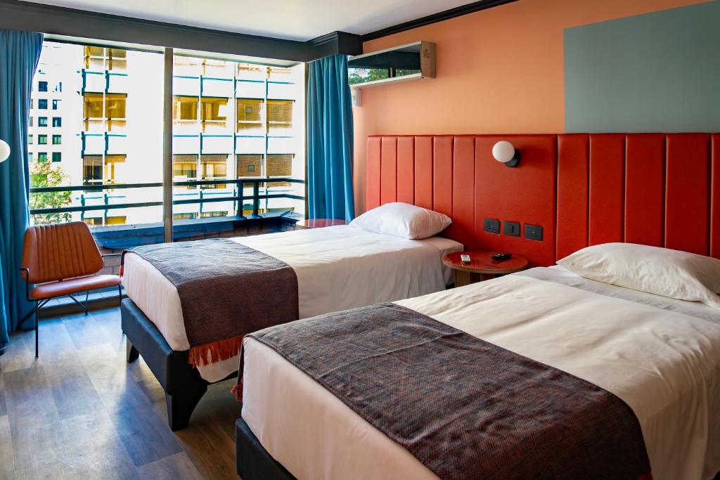 Postel nebo postele na pokoji v ubytování APT Serviced Apartments Santiago