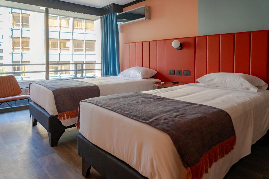 Postel nebo postele na pokoji v ubytování APT Serviced Apartments Santiago