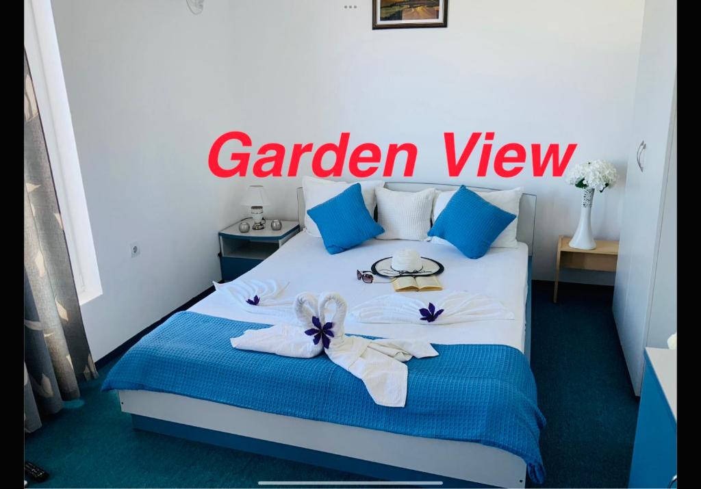 a bedroom with a bed with blue and white towels at Guest House Briz in Nesebar
