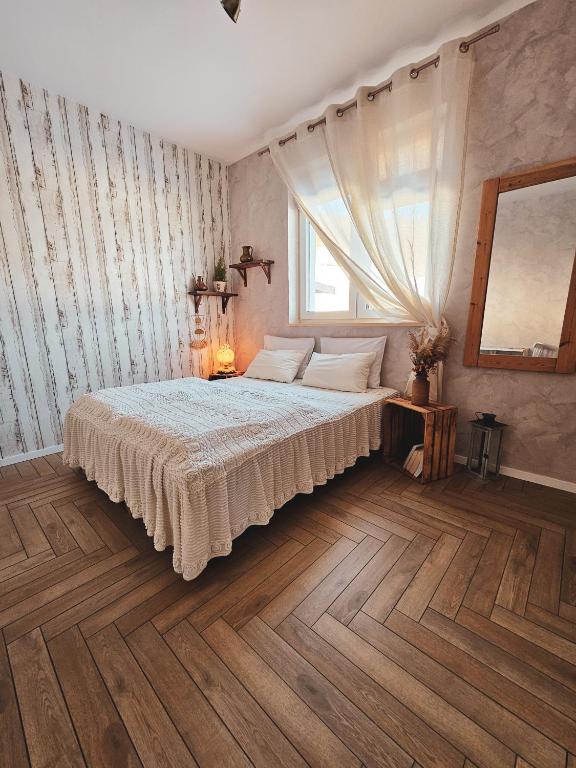 a bedroom with a large bed and a window at Lawendowy Raj in Pilchowice