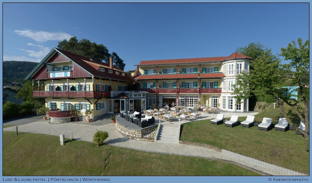 an aerial view of a large building with tables and chairs at Lust und Laune Hotel am Wörthersee in Pörtschach am Wörthersee