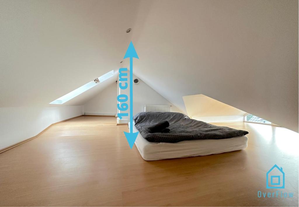 a room with a bed in the middle of a attic at Attic Room in Gdańsk