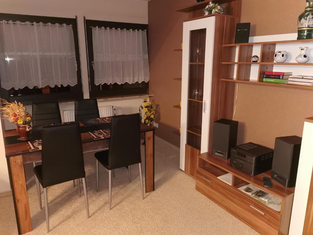 a living room with a dining room table and chairs at Ferienwohnung Anna in Monplaisir