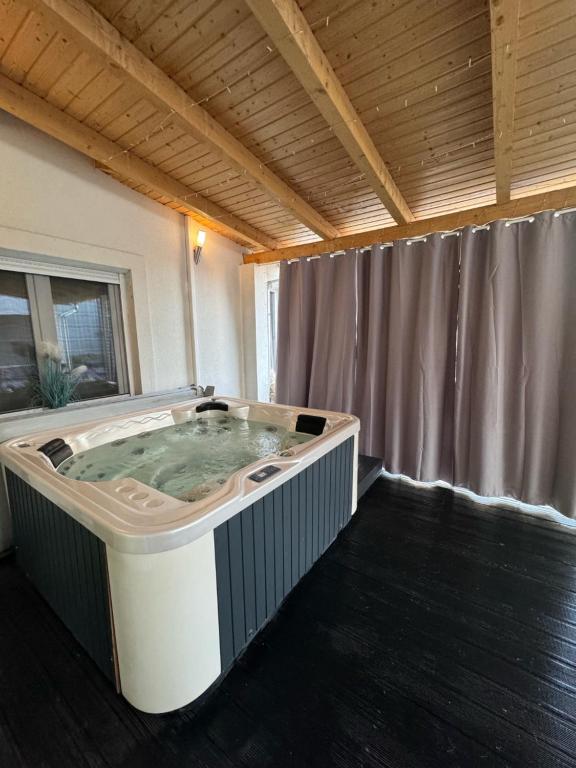 a hot tub in the middle of a room at Bogyó Family Land Budapest in Budapest