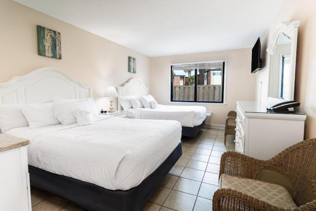 a hotel room with two beds and a window at Bright Modern Room First Floor Resort View in Pawleys Island