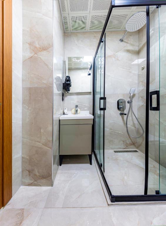 a bathroom with a shower and a sink at Dem Premium Hotel - Round Trip Airport Service - Istanbul International Airport in Arnavutköy