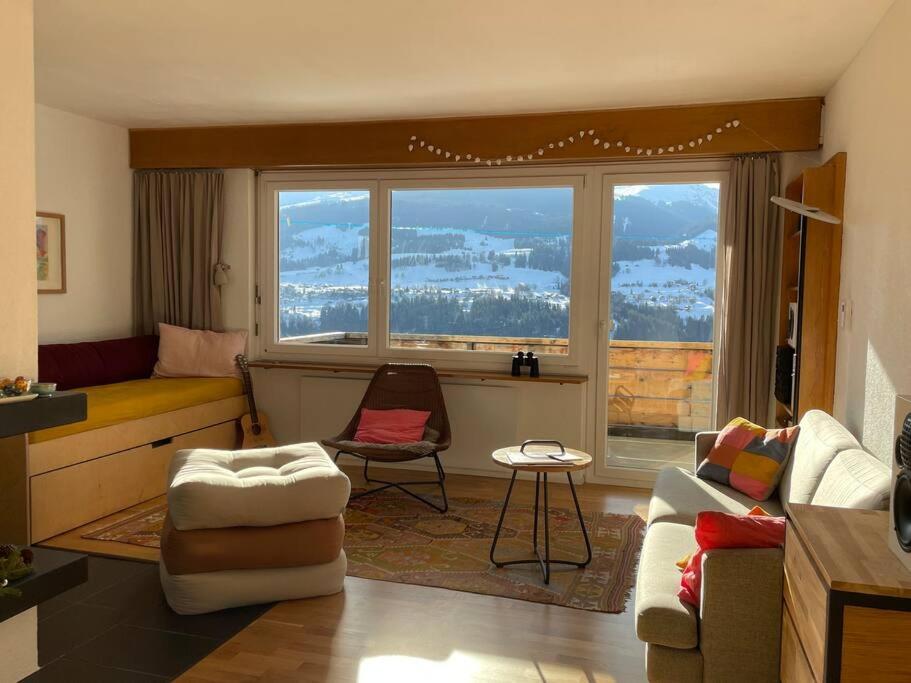 a living room with a couch and a chair at Casa Splendusa - sonnige Wohnung in Brigels in Breil/Brigels